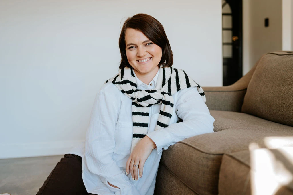 Mia Stoltz seated on a sofa, smiling warmly